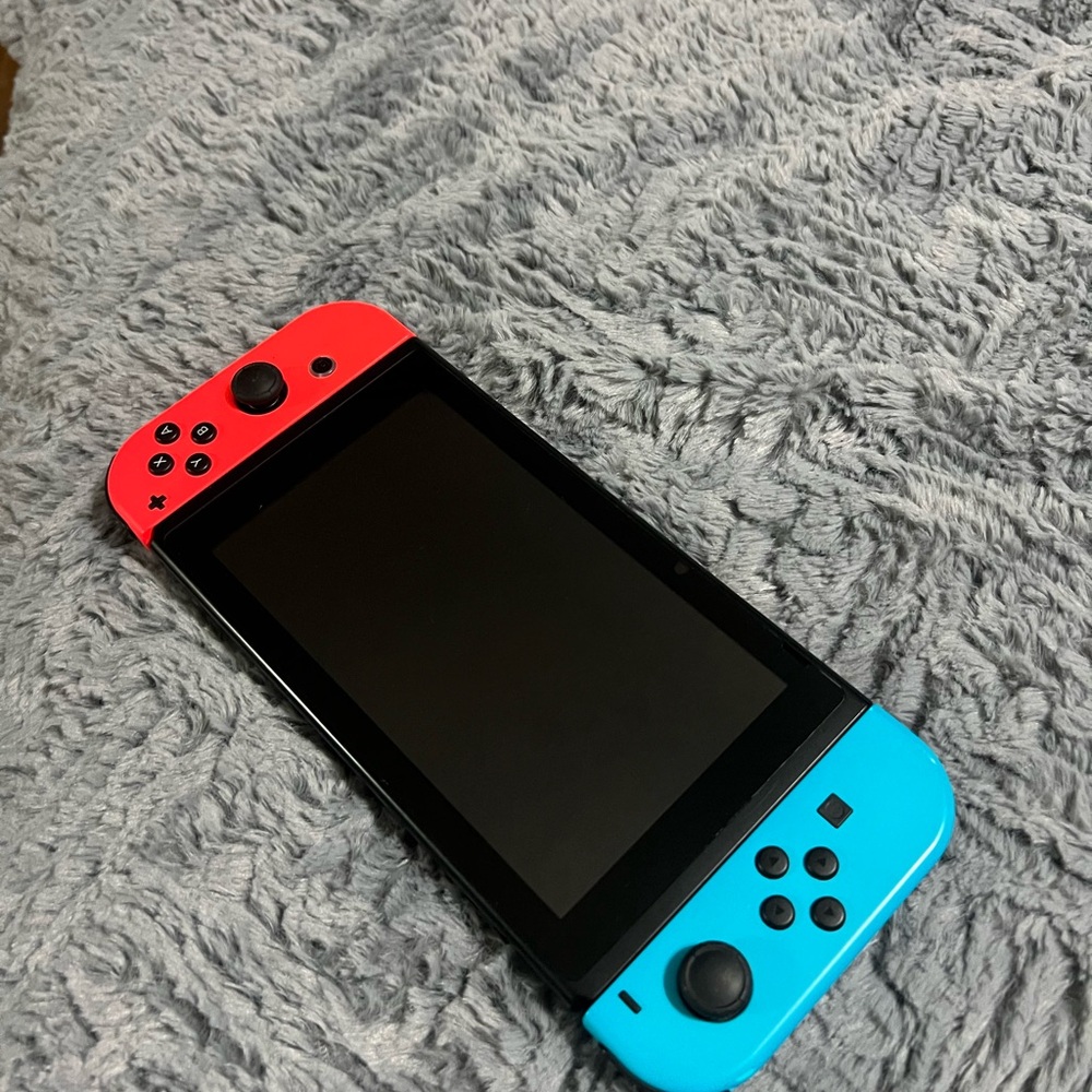 Nintendo Handheld Console with Red and Blue Controllers